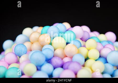Foam beads of various colors brightly colored on black background. Stock Photo