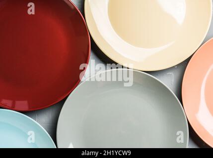 Clean different colour plates on the rustic background. Selective focus. Stock Photo
