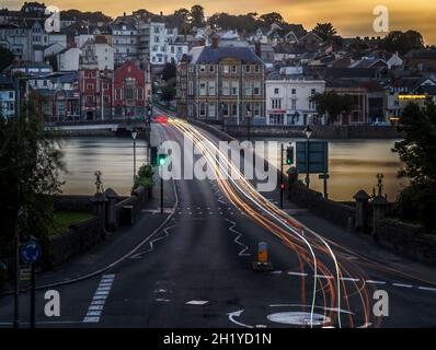 BIDEFORD, DEVON, UK - AUGUST 12 2021: Sunset evening view of Long Bridge with traffic light trails. Stock Photo