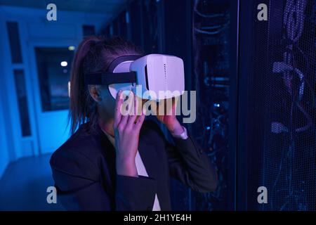 Woman is using VR headset in data center Stock Photo