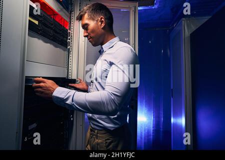 Experienced Caucasian IT technician upgrading computer hardware Stock Photo