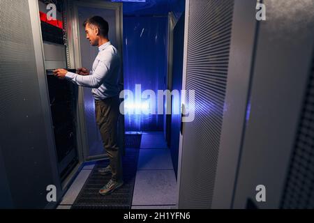 Expert Caucasian system administrator doing hardware refresh Stock Photo