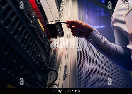 Experienced data center IT technician installing HDD Stock Photo