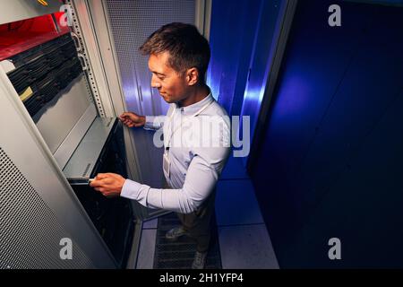Expert male engineer replacing old hardware component Stock Photo