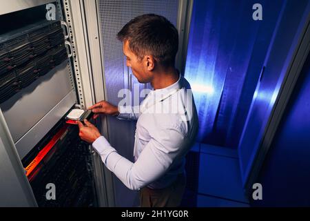 Skilled system administrator replacing old hardware component Stock Photo