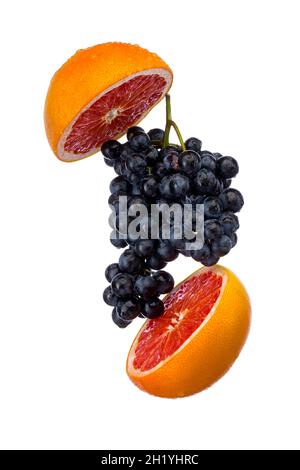 Dark blue grape with red grapefruit isolated on white background Stock Photo