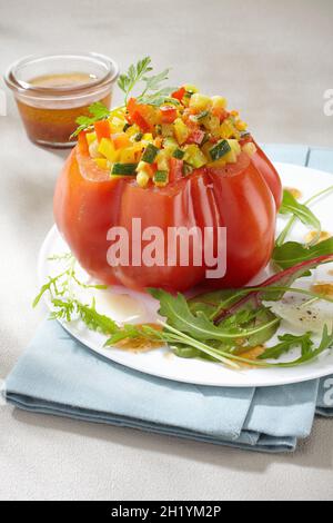 A beefsteak tomato filled with vegetables Stock Photo