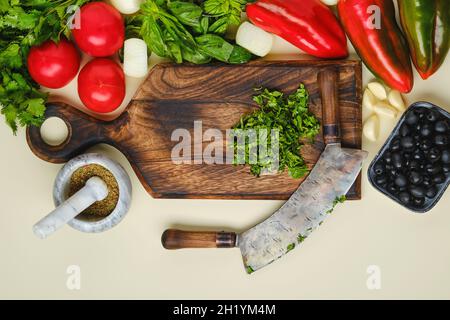 Top view of mezzaluna and ffresh vegetables Stock Photo