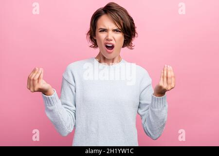 Photo of mad millennial brunette lady ask wear blue sweater isolated on pink color background Stock Photo