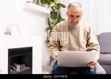 Senior working on a laptop, elderly man. Stock Photo