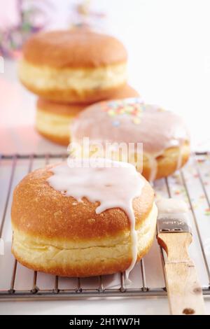 Glazed carnival doughnuts with colourful confetti decoration Stock Photo