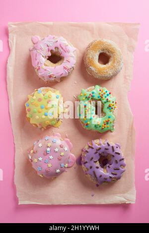 Doughnuts with glaze on a pink surface Stock Photo