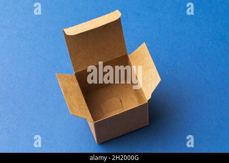Empty open cardboard box on blue background, template for designers Stock Photo