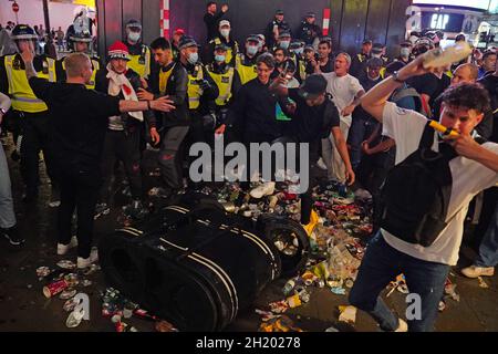 File photo dated 12-07-2021 of Police officer watch football fans as they kick a rubbish bin in Piccadilly Circus, London, after Italy beat England on penalties to win the UEFA Euro 2020 Final. The Euro 2020 final chaos at Wembley will not derail work towards a UK and Ireland bid for the 2030 World Cup, MPs have been told. Issue date: Tuesday October 19, 2021. Stock Photo