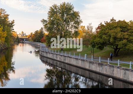 Rideau Canal, Hog's Back Locks in Ottawa, Canada. Autumn season in park with pathway along river Stock Photo