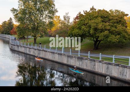 Ottawa, Canada - October 11, 2021: Rideau Canal, Hog's Back Locks in Ottawa, Canada. Autumn season in park with road along river Stock Photo