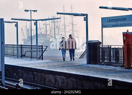 Young couple leaving the platform of S-train station Landungsbrücken in Hamburg, Germany. Stock Photo