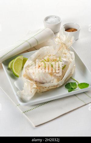 Cod in parchment paper Stock Photo