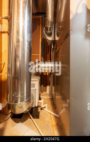 A wholehouse heavy duty dehumidifier with its duct attached to hvac furnace system of an house. This samples humidity of the circulating air and remov Stock Photo