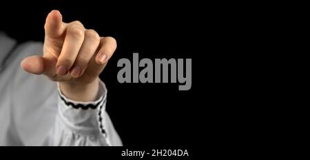 Pointing of index finger hand diretion gesture sign and showing touch or press the point. Banner with black background and copy space Stock Photo