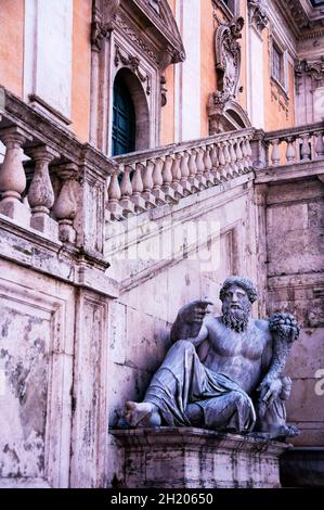 Ancient statues lay on couches as customary of the time to eat dinner, this one placed by Michelangelo in Palazzo Senatorio, Rome, Italy. Stock Photo