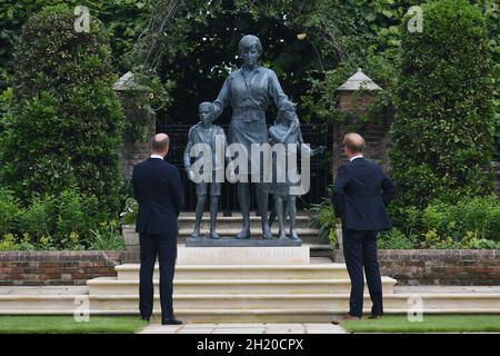File photo dated 01/07/21 of The Duke of Cambridge (left) and Duke of Sussex look at a statue they commissioned of their mother Diana, Princess of Wales, in the Sunken Garden at Kensington Palace, London. The Duke and Duchess of Cambridge have held a reception at Kensington Palace to mark the unveiling of the Diana, Princess of Wales statue. Issue date: Tuesday October 19, 2021. Stock Photo