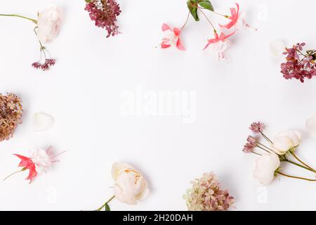 Autumn flowers composition. Frame made of pink rose, hydrangea flowers on white gray background. Flat lay Stock Photo