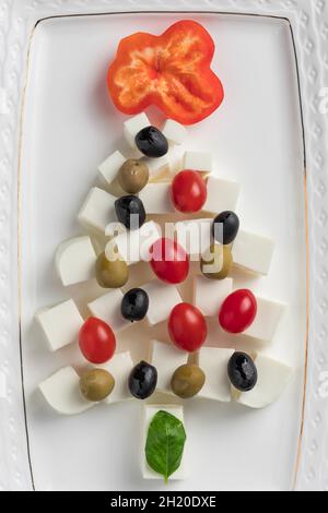 closeup of Christmas tree made from cheese, tomatoes, olives Stock Photo