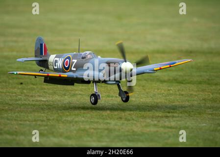 A RC model Spitfire landing at the Basingstoke Model Aero Club, Basingstoke, UK Stock Photo