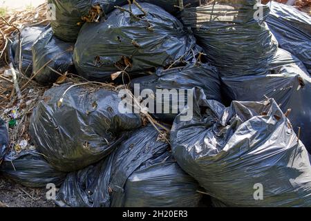 Big pile of black plastic garbage bags with trash stacked on the street trash  bags. on the street at utility workers strike day Stock Photo - Alamy