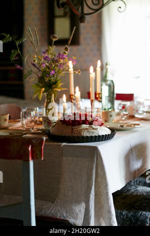 Pavlova on a festively set table Stock Photo