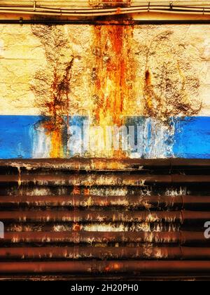 Bright, colorful, graphic color photograph of leaking and decaying pipes make beautiful patterns on the wall of the PATH train station in Hoboken, NJ, Stock Photo