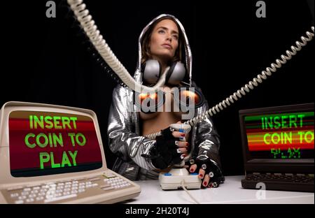 Woman with crazy costume using arcade joystick Stock Photo