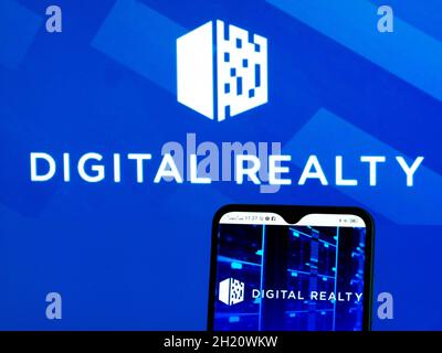 In this photo illustration, Digital Realty Trust, Inc. logo seen displayed on a smartphone and in the background. Stock Photo