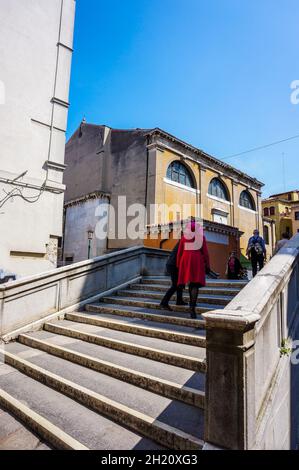 VENICE, ITALY - May 20, 2016: the People walking on stairs of a canal bridge in the city center. Stock Photo
