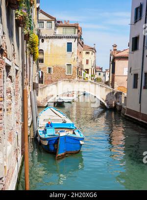 VENICE, ITALY - May 20, 2016: A canal with boat along old homes in the city center Stock Photo