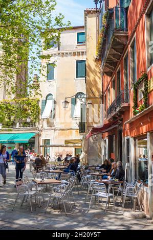 VENICE, ITALY - May 20, 2016: the People sitting outside by cafes and restaurants in the city center. Stock Photo