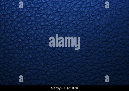 Dark blue leatherette texture background, faux leather pattern. Top view. Natural dark blue leather surface. Artificial eco leather closeup. Stock Photo