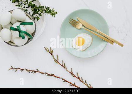 Easter flat lay with green eggs on a white marble Stock Photo