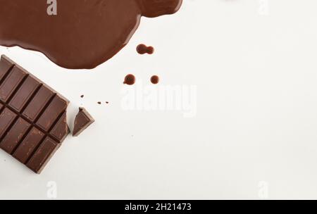 Background with pastry chocolate in tablet and melted on a white table. Top view. Horizontal composiiton. Stock Photo