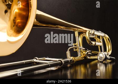 Trombone with transposer mounted on a white table. Front view. Horizontal composition. Stock Photo