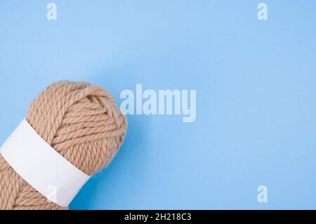 Vertical shot of isolated soft beige yarn ball on an a coral background  Stock Photo by wirestock
