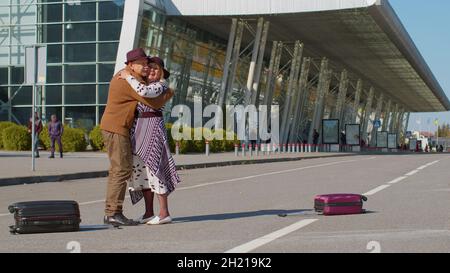 Senior old husband and wife retirees tourists reunion meeting in airport terminal after traveling Stock Photo
