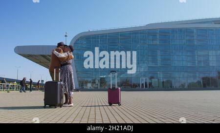 Senior old husband and wife retirees tourists reunion meeting in airport terminal after traveling Stock Photo