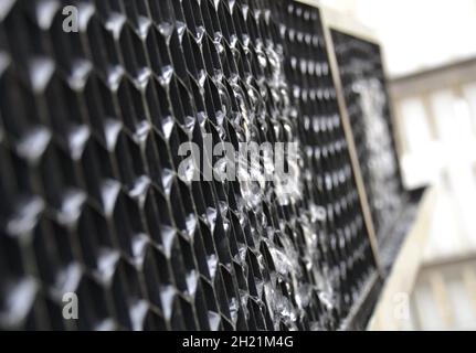 Closeup view of water leaking from the air intake louvers on an air conditioning HVAC plant system on a rooftop Stock Photo