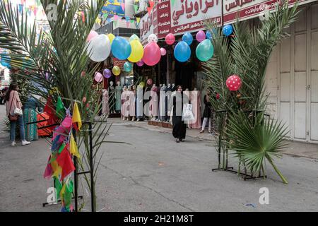 Nablus, Palestine. 19th Oct, 2021. View of a decorated street with palm leaves and balloons on the occasion of the birth of the Prophet Muhammad. Palestinians decorate the streets of the old city of Nablus on the occasion of the Prophet's birthday. Muslims celebrate the Prophet's birthday every year on the twelfth of Rabi' al-Awwal, the third month of the Islamic calendar. Credit: SOPA Images Limited/Alamy Live News Stock Photo