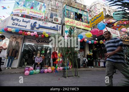 Nablus, Palestine. 19th Oct, 2021. View of a decorated street with palm leaves and balloons on the occasion of the birth of the Prophet Muhammad. Palestinians decorate the streets of the old city of Nablus on the occasion of the Prophet's birthday. Muslims celebrate the Prophet's birthday every year on the twelfth of Rabi' al-Awwal, the third month of the Islamic calendar. Credit: SOPA Images Limited/Alamy Live News Stock Photo