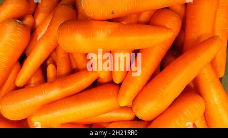 Many carrots are placed together in the shop for sale. Stock Photo