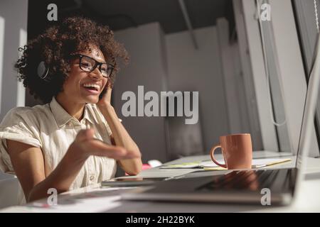 Pretty young woman talking during video call in office Stock Photo