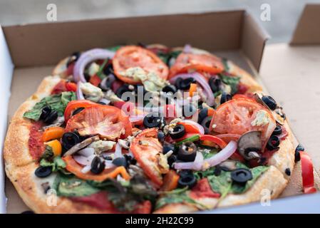Close-up of vegan Mediterranean style pizza in a pizza box Stock Photo